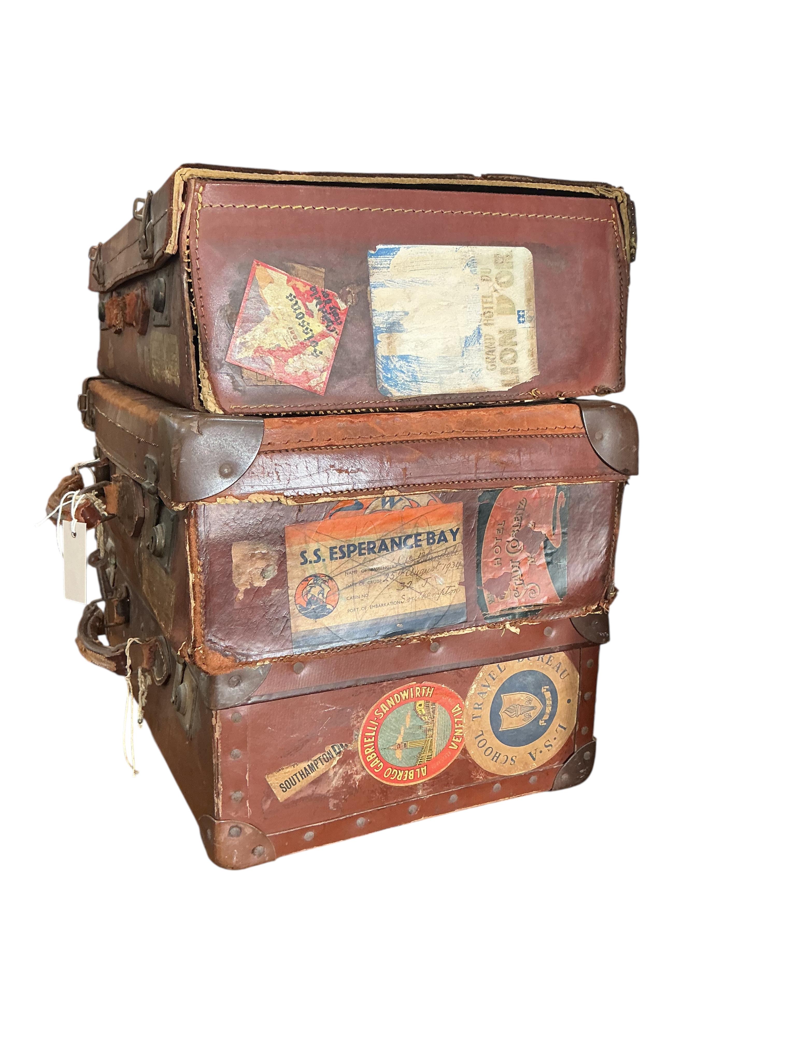 Three vintage suitcases, largest width 66cm